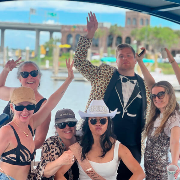 Laughing bachelorette group goofing around on party boat