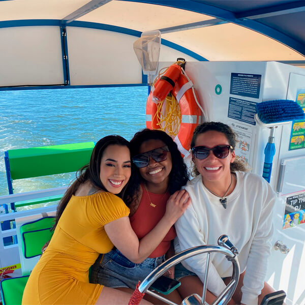 Bride and maid of honor dancing on boat
