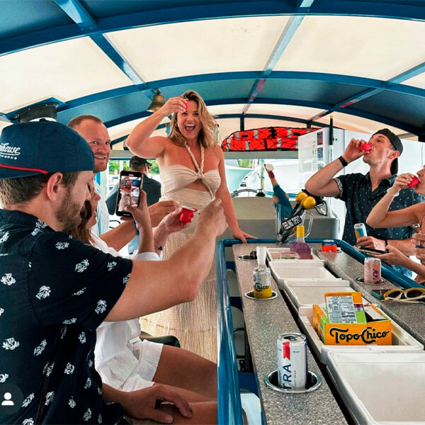Girls laughing and drinking cocktails on boat
