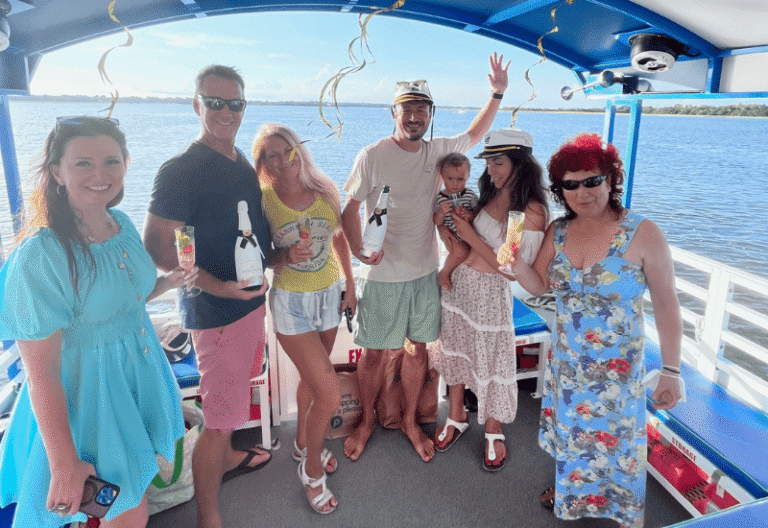 happy family laughing and cheering on a boat