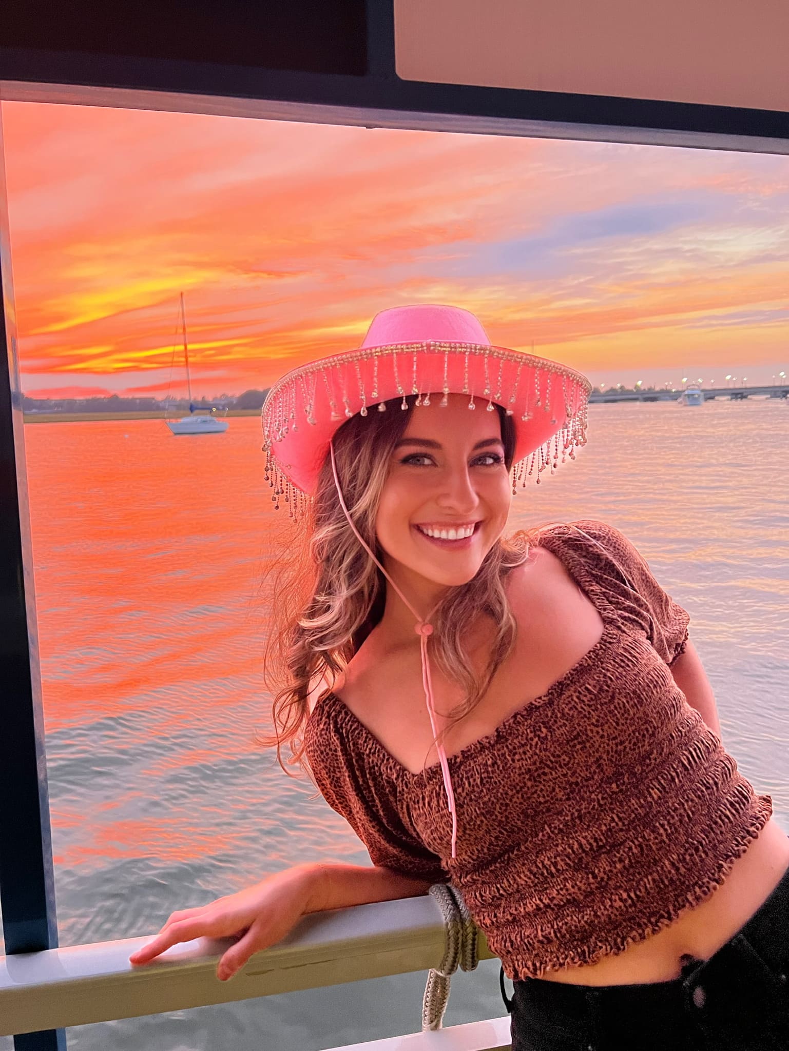 Friend of a birthday girl posing on the sunset aboard Harbor Bar Party Boat